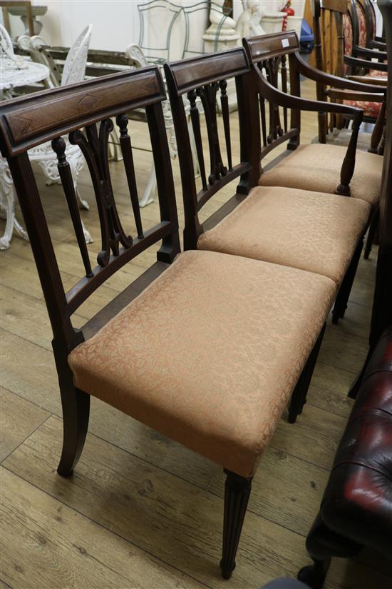 A George III mahogany elbow chair and two matching single chairs